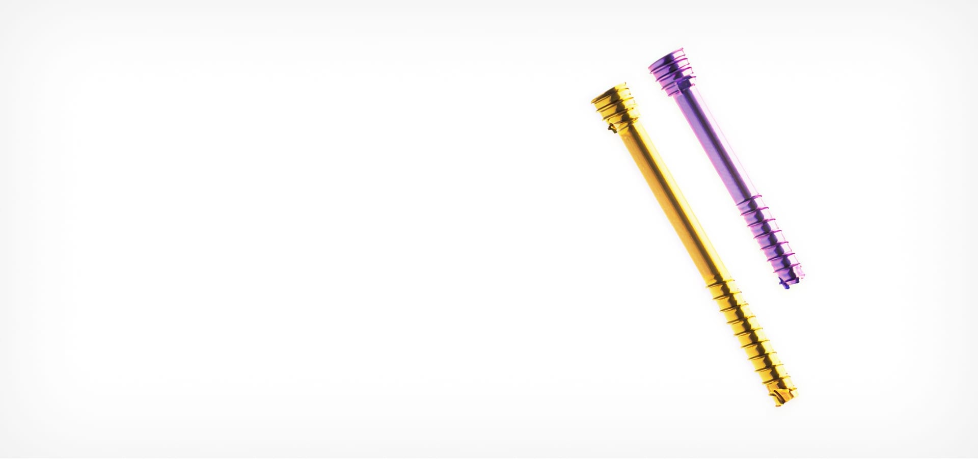 Two colorful gradient screws on a white background, aligned diagonally and facing opposite directions.