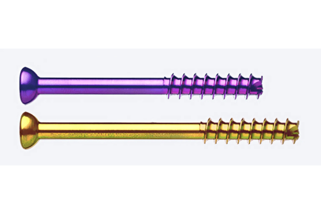 Two colorful orthopedic screws, one purple and one yellow, side by side against a white background.