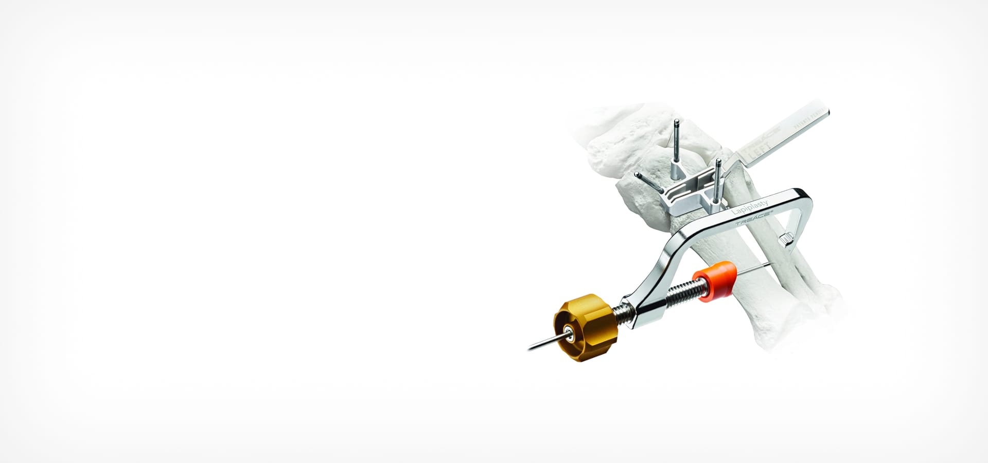 surgical instrument with drill component inserted into bone model on white background