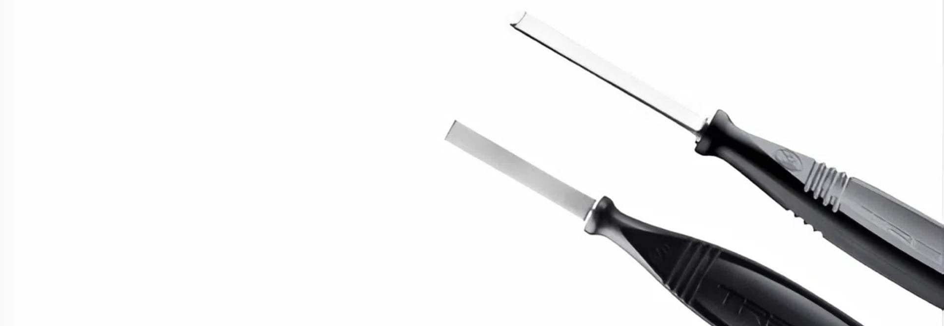 Two precision knives with black ergonomic handles against a white background.